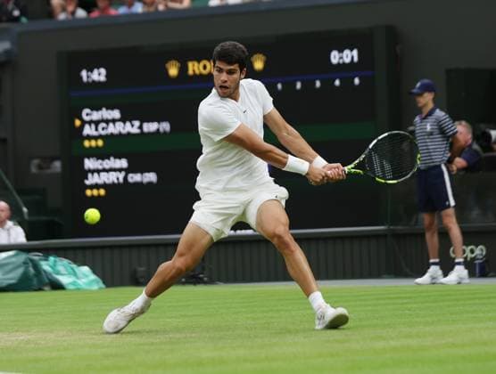 Spain s Carlos Alcaraz plays a backhand in his match against Chilean Nicolas Jarry on day six of the 2023 Wimbledon championships in London on Saturday, July 08, 2023.  LON2023070812 HUGOxPHILPOTT