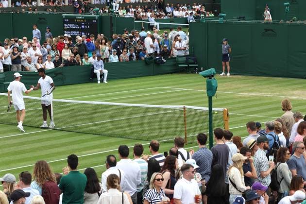 Wimbledon: Day Seven 9 July 2023, Wimbledon - Wimbledon Tennis Championships - Day Seven - Hayden Jones (AUS) and Manas Dhamne (IND) shake hands over the net after their Boys™ Singles match concludes - Photo: Charlotte Wilson Offside. Wimbledon UK Copyright: xCharlottexWilsonx xOffsidexOffside