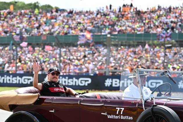 9th July 2023: Silverstone Circuit, Northamptonshire, England: Formula 1 2023 Aramco British F1 Grand Prix: Race Day; Valtteri Bottas of the Alfa Romeo-Ferrari team waves to fans while being driven round Silverstone track before the Grand Prix  ActionPlus12529165 SimonxWest