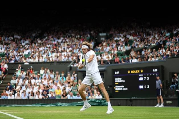 Wimbledon: Day Seven 9 July 2023, Wimbledon - Wimbledon Tennis Championships - Day Seven - Andrey Rublev returns the ball to Alexander Bublik with a two-handed backhand - Photo: Charlotte Wilson Offside. Wimbledon UK Copyright: xCharlottexWilsonx xOffsidexOffside