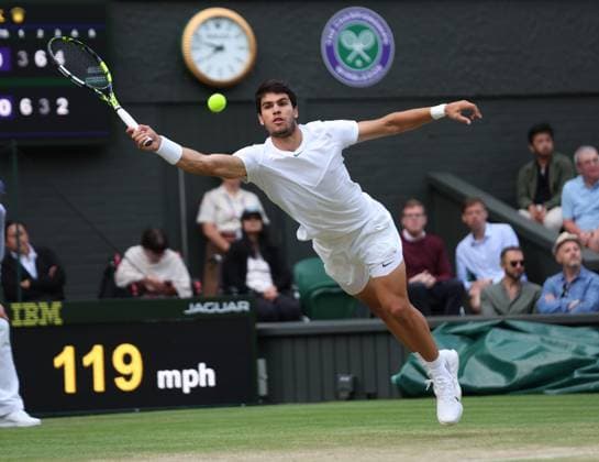 Spain s Carloss Alcaraz plays a forehand in his match against Italy s Matteo Berrettini on day eight of the 2023 Wimbledon championships in London on Monday, July 10, 2023.  LON20230710101 HUGOxPHILPOTT