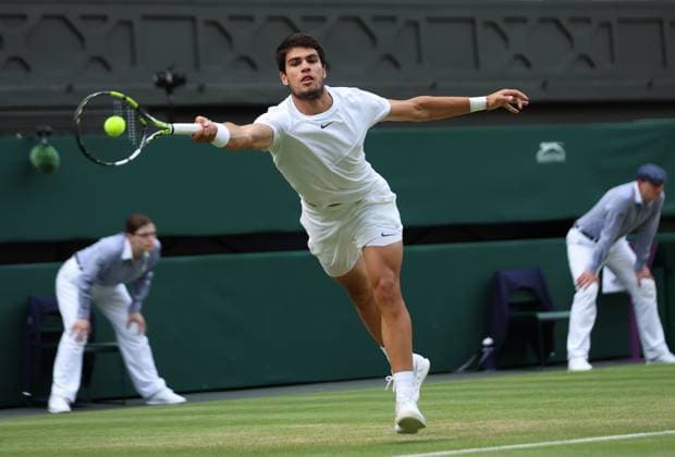 Spain s Carloss Alcaraz plays a forehand in his match against Italy s Matteo Berrettini on day eight of the 2023 Wimbledon championships in London on Monday, July 10, 2023.  LON20230710103 HUGOxPHILPOTT