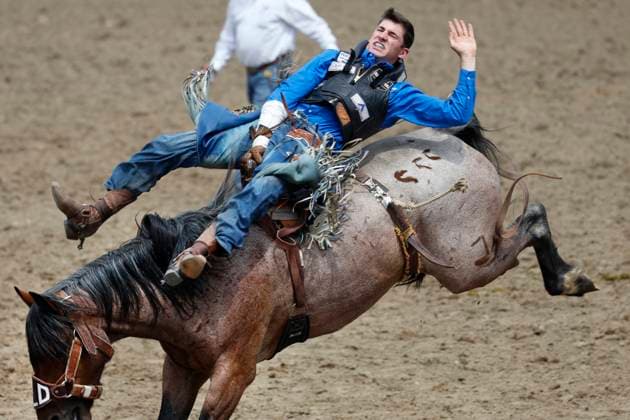 Sport Themen der Woche KW28 Sport Bilder des Tages Calgary, Alberta; Canada--- Cowboy Ty Pope (from Marshall, Montana) completes his ride on a horse called Twin Flame during the Bareback riding event at the Calgary Stampede rodeo on July 10, 2023. digital photo by Larry MacDougal