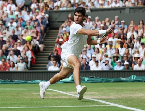 Spain s Carlos Alcaraz celebrates victory in his Men s quarterfinals match against Denmark s Holger Rune at the 2023 Wimbledon championships in London on Wednesday, July 12, 2023.  LON2023071255 HUGOxPHILPOTT