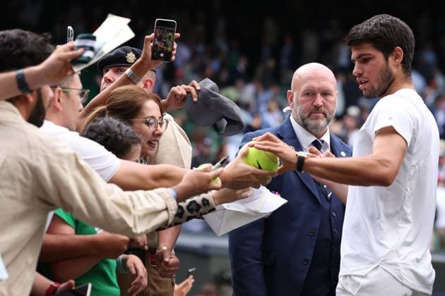 12th July 2023; All England Lawn Tennis and Croquet Club, London, England: Wimbledon Tennis Tournament; Carlos Alcaraz signs autographs for fans after he wins his match against Holger Rune  ActionPlus12530799 ShaunxBrooks