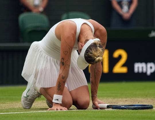 Tennis - 2023 Wimbledon Championships - Week Two - Day Eleven - All England lawn Tennis & Racquet Club, Wimbledon - Thursday 13th Ladies singles semi final Elina Svitolina (UKR) v Marketa Vondrousova (CZE) Marketa Vondrousova (CZE) drops to her knees after winning the match 