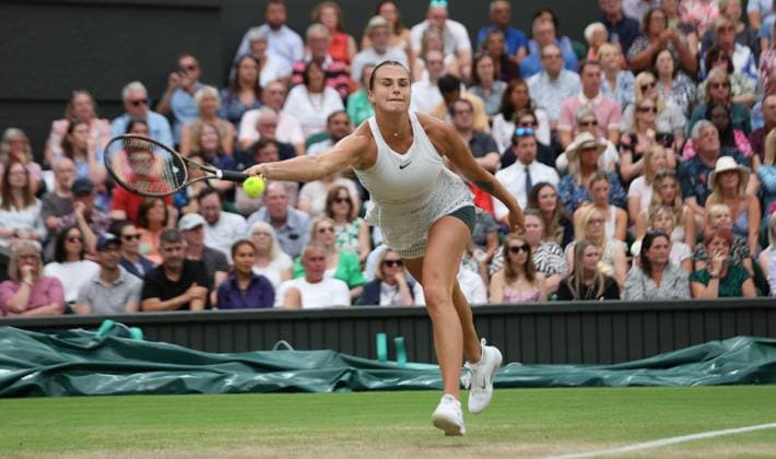 Belarussian Aryna Sabalenka plays a forehand in her Women s semifinals match against Tunisian Ons Jabeur at the 2023 Wimbledon championships in London on Thurssday, July 13, 2023. Jabeur won the match 6-7,6-4,6-3.  LON2023071344 HUGOxPHILPOTT