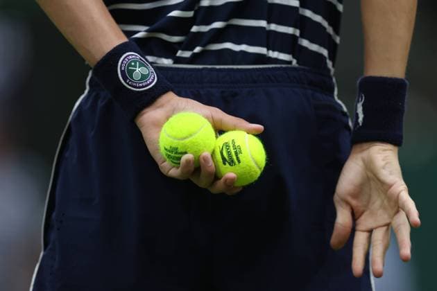Wimbledon: Day Eleven 13 July 2023, Wimbledon - Wimbledon Tennis Championships - Day Eleven - A ballboy holds two tennis balls behind their back - Photo: Charlotte Wilson Offside. Wimbledon UK Copyright: xCharlottexWilsonx xOffsidexOffside