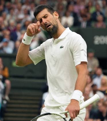 Tennis - 2023 Wimbledon Championships - Week Two - Day Twelve - All England lawn Tennis & Racquet Club, Wimbledon - Friday 14th Mens Semi final - Novak Djokovic v Jannik Sinner Novak Djokovic taunts the crowd with Mock crying after some started booing him 