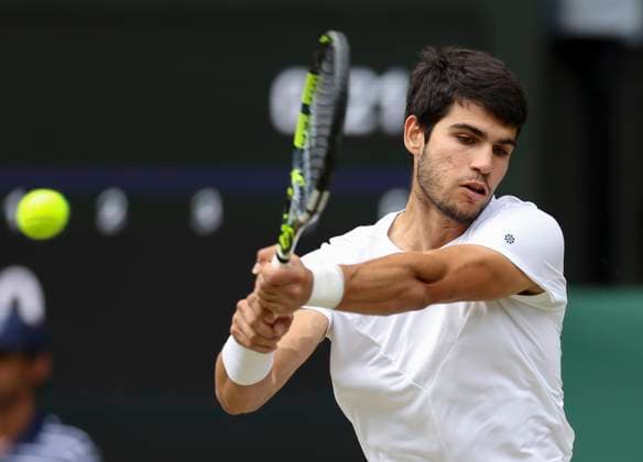(230716) -- LONDON, July 16, 2023 -- Carlos Alcaraz hits a return during the men s singles final match between Novak Djokovic of Serbia and Carlos Alcaraz of spain at Wimbledon Tennis Championships in London, Britain, July 16, 2023. ) (SP)BRITAIN-LONDON-TENNIS-WIMBLEDON-DAY 14 HanxYan 