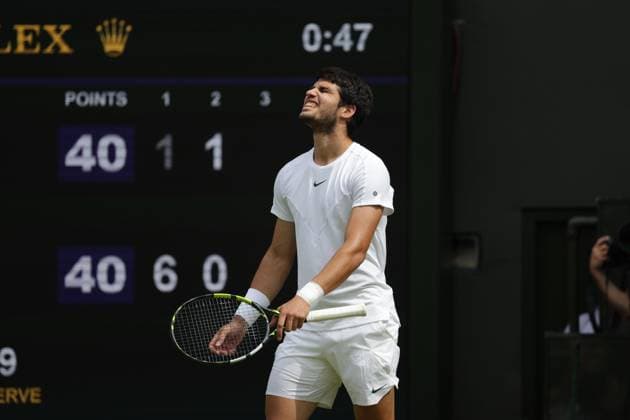 16th July 2023; All England Lawn Tennis and Croquet Club, London, England: Wimbledon Tennis Tournament; Mens singles final on centre court Novak Djokovic versus Carlos Alcaraz; Alcaraz returns long and winces  ActionPlus12531992 JohnxPatrickxFletcher