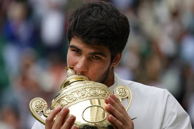 16th July 2023; All England Lawn Tennis and Croquet Club, London, England: Wimbledon Tennis Tournament; Carlos Alcaraz kisses the winners trophy after beating Djokovic in 5 sets  ActionPlus12532144 JohnxPatrickxFletcher