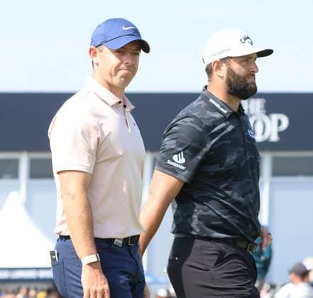 Northern Ireland s Rory Mcllroy smiles with Jon Rahm as he walks on the fourth fairway on the first day at the 151st Open Championship at Royal Liverpool Golf Club in Hoylake, England on Thursday, July 20, 2023.  LON20230720118 HUGOxPHILPOTT