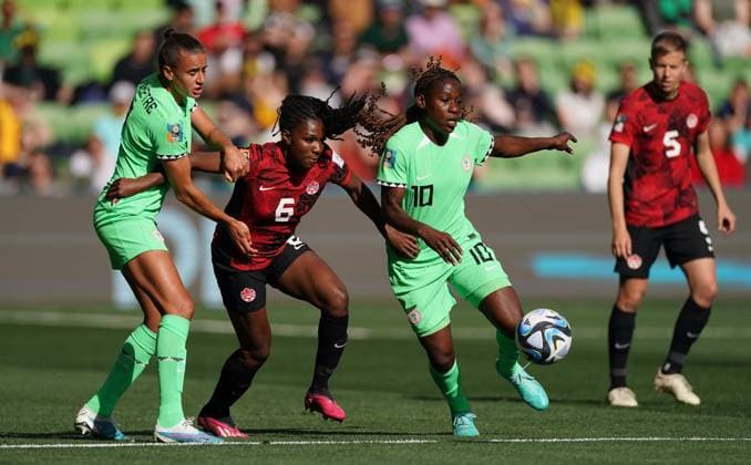 July 21, 2023, Melbourne, MB, Australia: Nigeria s Christy Ucheibe, right, protects the ball from Canada s Deanne Rose during first half Group B soccer action at the FIFA Women s World Cup in Melbourne, Australia, Friday, July 21, 2023. Canada News - July 21, 2023  - ZUMAc35_ 20230721_zaf_c35_007 Copyright: xScottxBarbourx