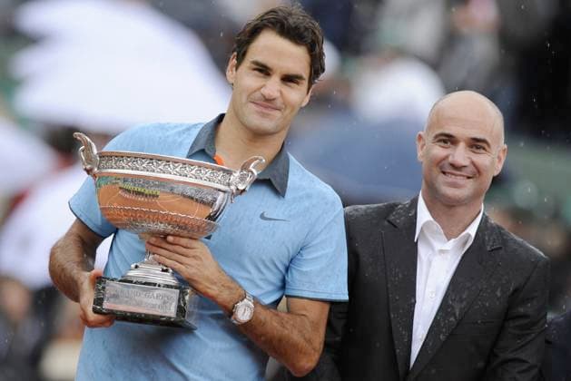 Tennis File Pictures Switzerland s Roger Federer receives the trophy from US former tennis player Andre Agassi following his victory during the men s singles final match of the French Open tennis tournament at the Roland Garros stadium in Paris, Sunday June 7, 2009. The victory gives Federer 14 Grand Slams, tying his career wins to American Pete Sampras. Federer won 6-1, 7-6 (7 1), 6-4. Photo by Corinne Dubreuil Cameleon ABACAPRESS.COM Paris - France  Copyright: xDubreuilxCorinne ABACAx 190559_020 DubreuilxCorinne ABACAx 190559_020