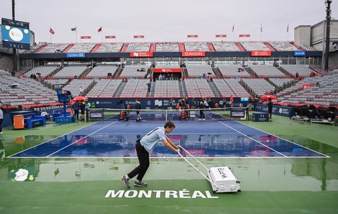 August 7, 2023, Montreal, PQ, Canada: A worker pushes water off centre court during a break in play due to rain at the National Bank Open tennis tournament in Montreal, Monday, August 7, 2023. Canada News - August 7, 2023  - ZUMAc35_ 20230807_zaf_c35_053 Copyright: xGrahamxHughesx