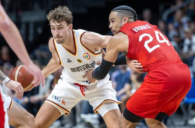 Basketball: Laenderspiele, Deutschland - Kanada, Mercedes-Benz Arena. Deutschlands Franz Wagner (l) kaempft gegen Dillon Brooks aus Kanada um den Ball. Basketball: Laenderspiel Deutschland - Kanada