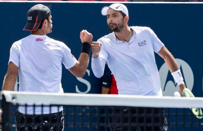 (230814) -- TORONTO, Aug. 14, 2023 -- Marcelo Arevalo (R) of Salvador and Jean-julien Rojer of the Netherlands celebrate scoring during the men s doubles final match between Rajeev Ram of the United States Joe Salisbury of Britain and Marcelo Arevalo of Salvador Jean-julien Rojer of the Netherlands at the 2023 National Bank Open in Toronto, Canada, on Aug. 13, 2023. (Photo by Xinhua) (SP)CANADA-TORONTO-TENNIS-NATIONAL BANK OPEN-MEN S DOUBLES FINAL ZouxZheng 