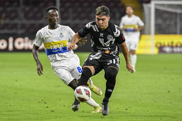 Union s Lazare Amani and Lugano s Ignacio Aliseda fight for the ball during a soccer match between Swiss FC Lugano and Belgian Royale Union Saint-Gilloise, Thursday 31 August 2023 in Geneva, Switzerland, the return leg of the play-off for the UEFA Europa League competition. LAURIExDIEFFEMBACQ  x73078628x