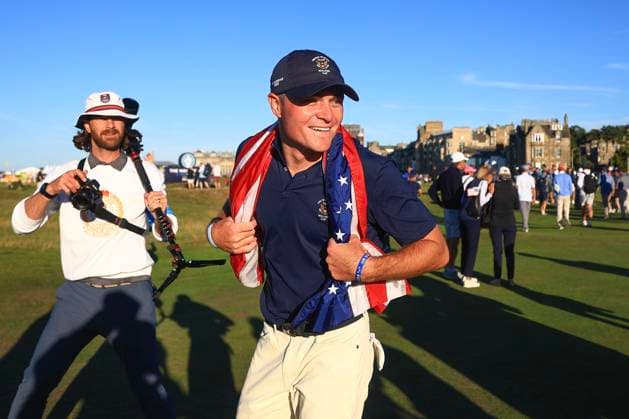 3rd September 2023; Old Course at St Andrews, St Andrews, Fife, Scotland; Walker Cup, Final Round; Austin Greaser of the United States of America celebrates with an American flag after securing the point which retained the Walker Cup for the USA  ActionPlus12550604 DavidxYoung