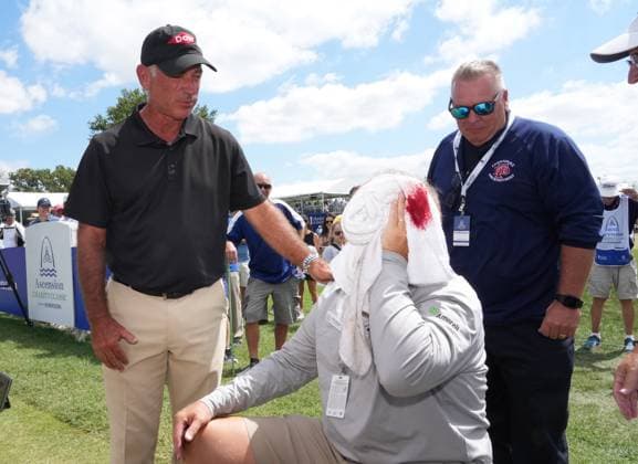 Golfer Corey Pavin (L) checks on the welfare of a spectator after his golf ball hit the man in the head on another hole during the Ascension Charity Classic Golf Tournament at Norwood Hills Country Club in St. Louis on Saturday, September 9, 2023. The man was transported to a local hospital for stitches.  SLP2023090910 BILLxGREENBLATT