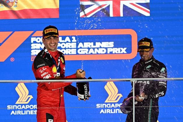 (230918) -- SINGAPORE, Sept. 18, 2023 -- Ferrari driver Carlos Sainz (L) of Spain and Mercedes driver Lewis Hamilton of Britain celebrate with champagne on the podium after the Formula One Singapore Grand Prix Night Race at the Marina Bay Street Circuit, Sept. 17, 2023. (Photo by Xinhua) (Photo by Xinhua) (SP)SINGAPORE-F1-SINGAPORE GRAND PRIX ThenxChihxWey 