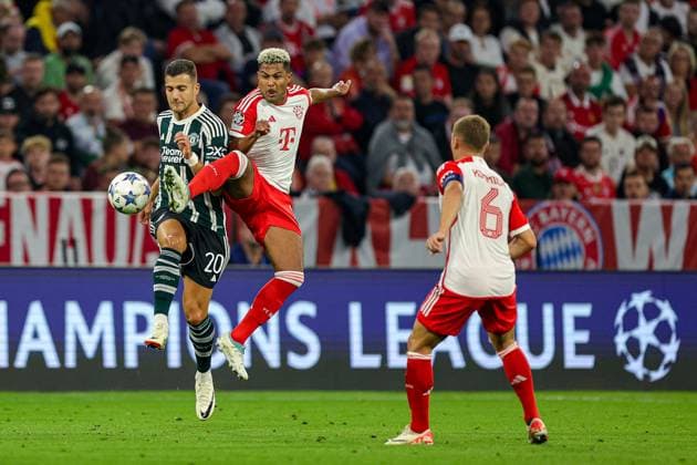 Bayern Munich v Manchester United, ManU Champions League 20 09 2023. Diogo Dalot (20) of Manchester United and Serge Gnabry (7) of Bayern Munich clash in the air during the Champions League match between Bayern Munich and Manchester United at Allianz Arena, Munich, Germany on 20 September 2023. Editorial use only , Copyright: xNigelxKeenex PSI-18044-0018