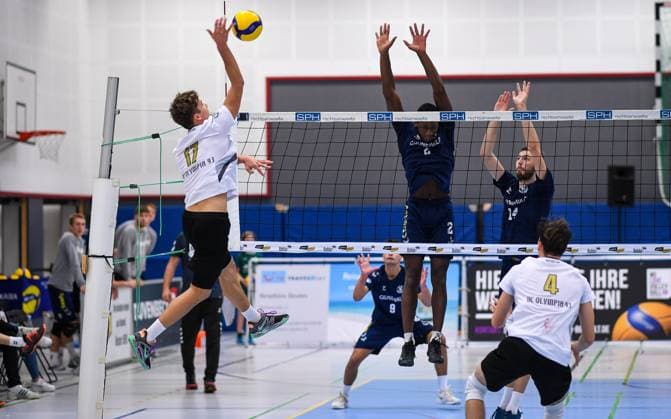 Volleyball, Saison 2023 2024, 2. Bundesliga Nord, 01.10.2023, 04. Spieltag, Herren, TuB Bocholt (blau) vs. VCO Berlin (weiss) v.l.: Fritz Vaehning (VCO Berlin), Rudy Schneider (TuB Bocholt), Florian Wissing (TuB Bocholt), Bocholt Euregiohalle Nordrhein-Westfalen Deutschland