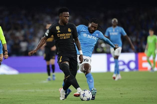Vinicius Junior of Real Madrid CF and Andre Zambo Anguissa of SSC Napoli compete for the ball during the Champions League Group C football match between SSC Napoli and Real Madrid FC at Diego Armando Maradona stadium in Naples (Italy), October 3rd, 2023. cesarexpurini
