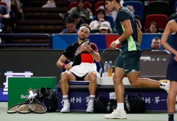 (231011) -- SHANGHAI, Oct. 11, 2023 -- Grigor Dimitrov of Bulgaria looks at his racket during the men s singles round of 16 match between Carlos Alcaraz of Spain and Grigor Dimitrov of Bulgaria at the ATP, Tennis Herren Shanghai Masters tennis tournament in Shanghai, east China, Oct. 11, 2023. ) (SP)CHINA-SHANGHAI-TENNIS-ATP TOUR-SHANGHAI MASTERS(CN) WangxLili 