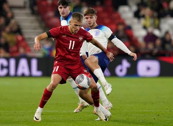 Nottingham, England, 12th October 2023. James McAtee of England tackles Vladimir Lucic of Serbia during the UEFA European Under-21 Championship Qualifier match at the City Ground, Nottingham. Picture credit should read: Andrew Yates Sportimage EDITORIAL USE ONLY. No use with unauthorised audio, video, data, fixture lists, club league logos or live services. Online in-match use limited to 120 images, no video emulation. No use in betting, games or single club league player publications. SPI-2644-0042
