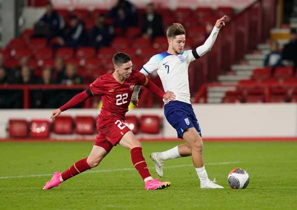 Nottingham, England, 12th October 2023. James McAtee of England tackled by Mitar Ergelas during the UEFA European Under-21 Championship Qualifier match at the City Ground, Nottingham. Picture credit should read: Andrew Yates Sportimage EDITORIAL USE ONLY. No use with unauthorised audio, video, data, fixture lists, club league logos or live services. Online in-match use limited to 120 images, no video emulation. No use in betting, games or single club league player publications. SPI-2644-0044