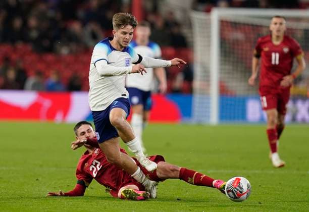 Nottingham, England, 12th October 2023. James McAtee of England tackled by Mitar Ergelas during the UEFA European Under-21 Championship Qualifier match at the City Ground, Nottingham. Picture credit should read: Andrew Yates Sportimage EDITORIAL USE ONLY. No use with unauthorised audio, video, data, fixture lists, club league logos or live services. Online in-match use limited to 120 images, no video emulation. No use in betting, games or single club league player publications. SPI-2644-0047