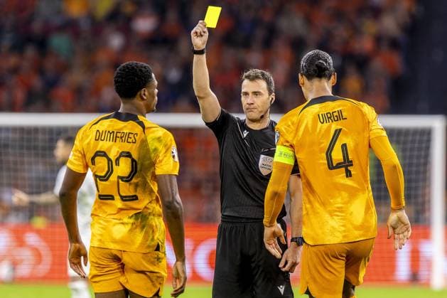 AMSTERDAM, 13-10-2023 JohanCruyff Arena, Football Euro2024 Qualifier between Netherlands and France. Netherlands player Denzel Dumfries (L) receives yellow card from referee Felix Zwayer (R) during the game Netherlands - France. Netherlands - France  x22734303x Copyright:
