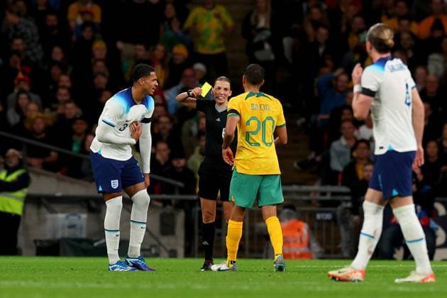 13th October 2023; Wembley Stadium, London, England; International Football Friendly, England versus Australia; Referee Stephanie Frappart shows a yellow card to Keanu Baccus of Australia and Levi Colwill of England  ActionPlus12564041 ShaunxBrooks