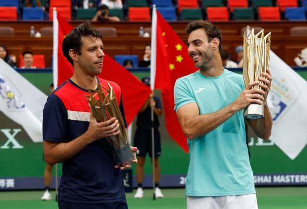 (231015) -- SHANGHAI, Oct. 15, 2023 -- First placed Marcel Granollers (R) of Spain Horacio Zeballos of Argentina celebrate with their trophies during the awarding ceremony of the men s doubles event at the ATP, Tennis Herren World Tour Shanghai Masters tennis tournament at Qizhong Forest Sports City Arena in Shanghai, east China, Oct. 15, 2023. ) (SP)CHINA-SHANGHAI-TENNIS-ATP TOUR-SHANGHAI MASTERS(CN) WangxLili 