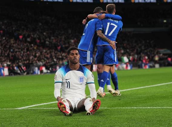 Football - 2024 UEFA European Championships - Qualifying - Group C - England vs Italy - Wembley Stadium - Tuesday 17th October 2023. Italy players celebrate goal Gianluca Scamacca™s goal as Marcus Rashford of England sits dejected Colorsport Andrew Cowie 