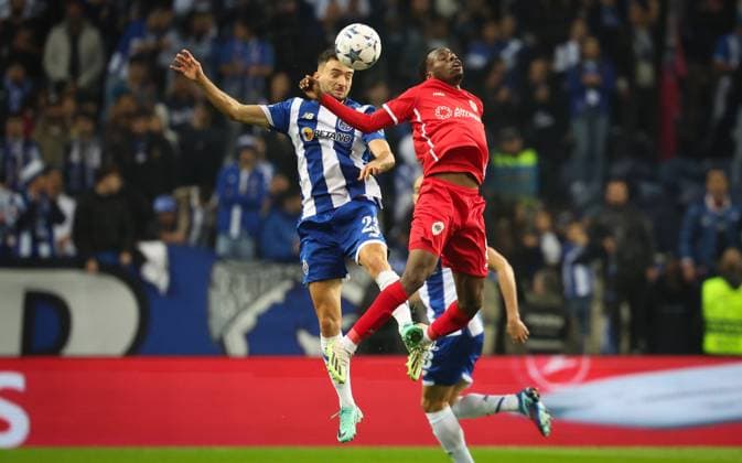 Porto s Joao Mario and Antwerp s Alhassan Yusuf Abdullahi fight for the ball during a game between Portuguese FC Porto and Belgian soccer team Royal Antwerp FC, on Tuesday 07 November 2023, in Porto, Portugal, on day four of the Champions League group stage, in the group H. VIRGINIExLEFOUR  x79483181x
