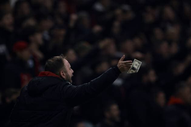 Milan, Italy, 7th November 2023. A fan waves fake money bearing an image of former AC Milan goalkeeper Gianluigi Donnarumma of PSG during the UEFA Champions League match at Giuseppe Meazza, Milan. Picture credit should read: Jonathan Moscrop Sportimage EDITORIAL USE ONLY. No use with unauthorised audio, video, data, fixture lists, club league logos or live services. Online in-match use limited to 120 images, no video emulation. No use in betting, games or single club league player publications. SPI-2699-0047