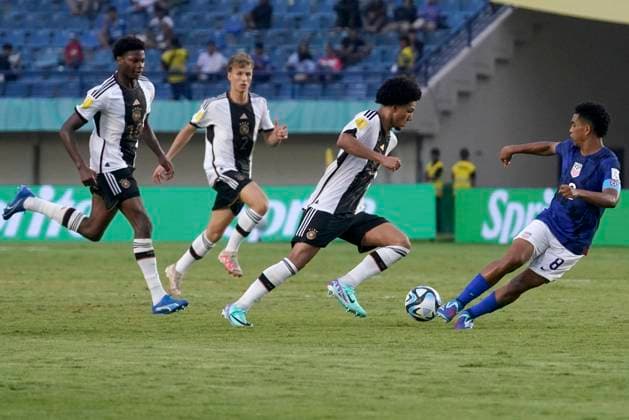 (231121) -- BANDUNG, Nov. 21, 2023 -- Eric da Silva Moreira (2nd R) of Germany vies with Pedro Soma (1st R) of the United States during the round of 16 match of the FIFA U-17 World Cup Indonesia 2023 between Germany and the United States at Jalak Harupat Stadium in Bandung, West Java, Indonesia, Nov. 21, 2023. (Photo by Xinhua) (SP)INDONESIA-BANDUNG-FIFA-WORLD CUP U17, U 17 ROUND OF 16-GER VS USA SeptianjarxMuharam 