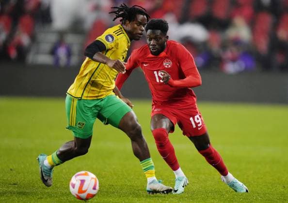 November 21, 2023, Toronto, ON, Canada: Canada s Alphonso Davies (19) moves past Jamaica s Dexter Lembikisa (2) during first half CONCACAF Nations League quarterfinal soccer action in Toronto on Tuesday, November 21, 2023. Canada News - November 21, 2023  - ZUMAc35_ 20231121_zaf_c35_183 Copyright: xChrisxYoungx