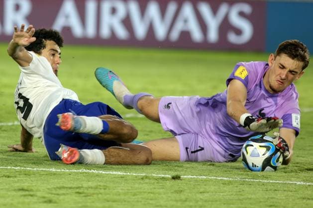(231125) -- SURAKARTA, Nov. 25, 2023 -- France s goalkeeper Paul Argney (R) makes a save from Amirbek Saidov of Uzbekistan during the quarterfinal between France and Uzbekistan at the FIFA U-17 World Cup Indonesia 2023 at the Manahan Stadium in Surakarta, Central Java, Indonesia, Nov. 25, 2023. (Photo by Yanur Xinhua) (SP)INDONESIA-SURAKARTA-FIFA-WORLD CUP U17, U 17 QUARTERFINAL-FRA VS UZB Yanuar 