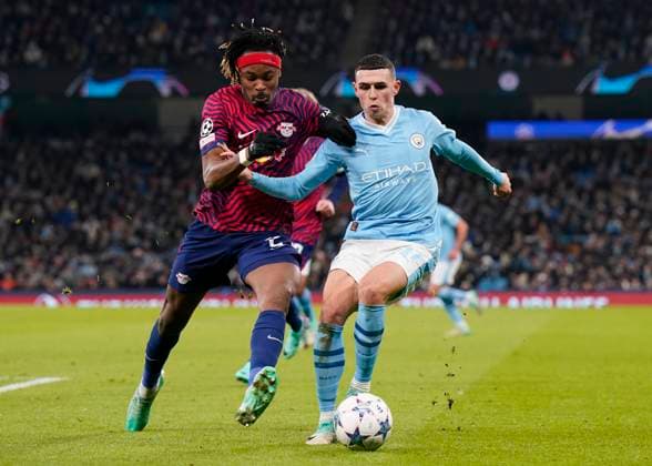 Manchester, England, 28th November 2023. Mohamed Simakan of RB Leipzig tackles Phil Foden of Manchester City during the UEFA Champions League match at the Etihad Stadium, Manchester. Picture credit should read: Andrew Yates Sportimage EDITORIAL USE ONLY. No use with unauthorised audio, video, data, fixture lists, club league logos or live services. Online in-match use limited to 120 images, no video emulation. No use in betting, games or single club league player publications. SPI-2749-0027