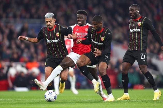 Arsenal v Lens 29 November 2023, London - Champion™s League Football, Group B - Arsenal v Lens - Facundo Medina of RC Lens and Kevin Danso of RC Lens tackle Bukayo Saka of Arsenal - Photo: Charlotte Wilson Offside. London UK Copyright: xCharlottexWilsonx xOffsidexOffside