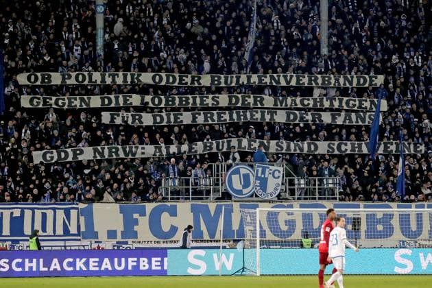 02.12.2023, xgox, Fussball 2.Bundesliga, 1.FC Magdeburg - 1.FC Kaiserslautern emspor, v.l. Fans, Stimmung, Schals, Fahnen, Besucher, Ultras, Trikots Spruchband Plakat gegen die Polizei (DFL DFB REGULATIONS PROHIBIT ANY USE OF PHOTOGRAPHS as IMAGE SEQUENCES and or QUASI-VIDEO) Magdeburg