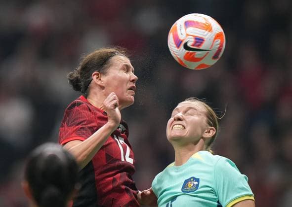 December 5, 2023, VANCOUVER, BC, CANADA: Canada s Christine Sinclair, left, gets her head on the ball in front of Australia s Clare Hunt to assist on a goal by teammate Quinn, not seen, during the first half of an International Friendly, Länderspiel, Nationalmannschaft soccer match, in Vancouver, on Tuesday, December 5, 2023. Canada News - December 5, 2023 - ZUMAc35_ 20231205_zaf_c35_125 Copyright: xDarrylxDyckx