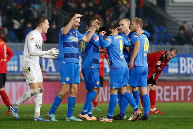 08.12.2023, xavx, Fussball 2.Bundesliga, SV Wehen Wiesbaden - Eintracht Braunschweig emspor, v.l. Torwart Ron-Thorben Hoffmann (Eintracht Braunschweig), Ermin Bicakcic (Eintracht Braunschweig), Rayan Philippe (Eintracht Braunschweig) jubeln jubelt nach Spielende. (DFL DFB REGULATIONS PROHIBIT ANY USE OF PHOTOGRAPHS as IMAGE SEQUENCES and or QUASI-VIDEO) Wiesbaden