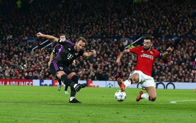 Harry Kane of Bayern Munich has a shot blocked by Bruno Fernandes of Manchester United, ManU Manchester United v Bayern Munich, UEFA Champions League, Group A, Football, Old Trafford, Manchester, UK - 12 Dec 2023 EDITORIAL USE ONLY No use with unauthorised audio, video, data, fixture lists, club league logos or live services. Online in-match use limited to 120 images, no video emulation. No use in betting, games or single club league player publications. Copyright: xMattxWest Shutterstockx 14254194aw