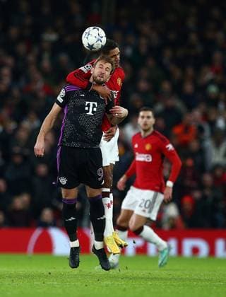 Raphaël Varane of Manchester United, ManU challenges Harry Kane of Bayern Munich in a header Manchester United v Bayern Munich, UEFA Champions League, Group A, Football, Old Trafford, Manchester, UK - 12 Dec 2023 EDITORIAL USE ONLY No use with unauthorised audio, video, data, fixture lists, club league logos or live services. Online in-match use limited to 120 images, no video emulation. No use in betting, games or single club league player publications. Copyright: xMattxWest Shutterstockx 14254194bf