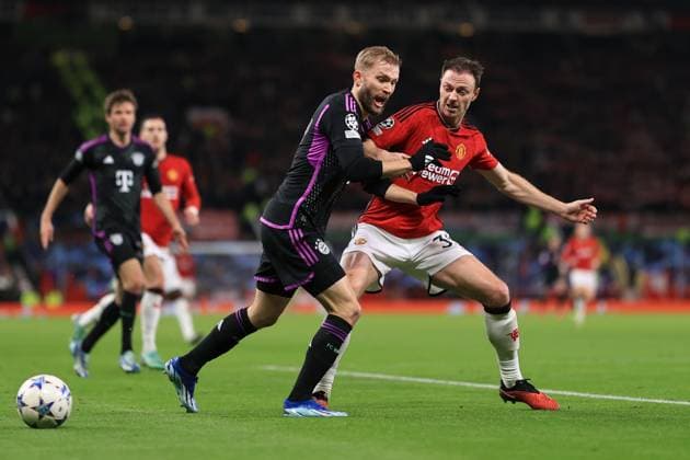 Football - UEFA Champions League - Group A - Manchester United, ManU v Bayern Munich 12th December 2023 - UEFA Champions League - Group A - Manchester United v Bayern Munich - Konrad Laimer of Bayern Munich is tackles by Jonny Evans of Manchester United - Photo: Simon Stacpoole Offside. Manchester UK Copyright: xSimonxStacpoolexOffside